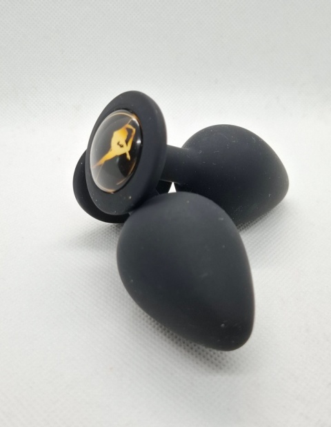 Limitowany korek analny „Pole Dance” – czarny silikonowy butt plug z ozdobną grafiką tancerki na rurze w złotym kolorze.