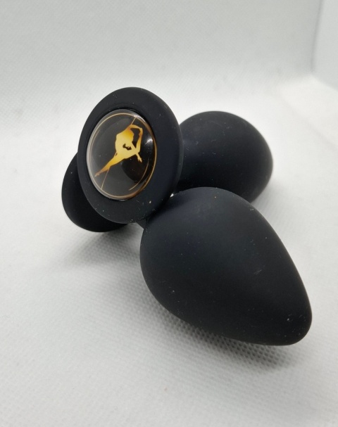 Limitowany korek analny „Pole Dance” – czarny silikonowy butt plug z ozdobną grafiką tancerki na rurze w złotym kolorze.